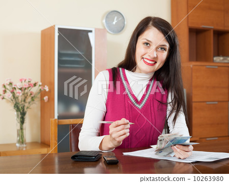 Happy brunette girl with money and documents Happy brunette girl with money and documents 10263980