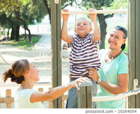 Happy parents with child training with pull-up bar Happy parents with child training with pull-up bar 10264054
