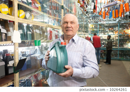 man holds motor oil in store man holds motor oil in store 10264261