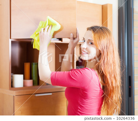 woman in red cleaning wooden furiture woman in red cleaning wooden furiture 10264336