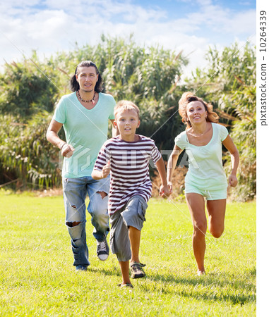 couple with child playing running in summer couple with child playing running in summer 10264339