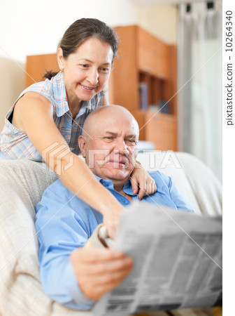 Happy couple of grandparents with newspaper 10264340