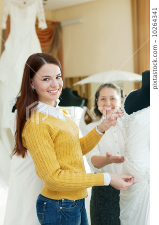 Happy mature mother with daughter chooses bridal gown Happy mature mother with daughter chooses bridal gown 10264341