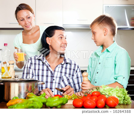 Family cooking in the kitchen Family cooking in the kitchen 10264388