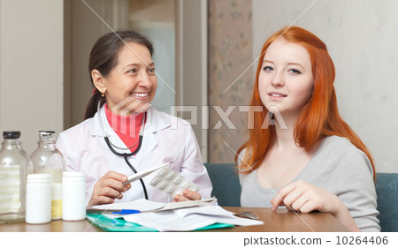 patient listening the doctor at table patient listening the doctor at table 10264406
