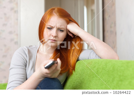 Red-haired teenager girl having disappointment Red-haired teenager girl having disappointment 10264422