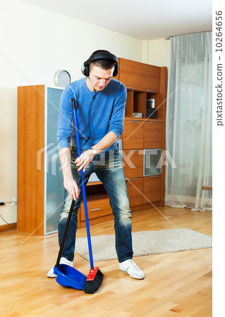 Handsome man cleaning living room 10264656