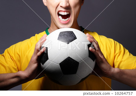 Excited sport man shouting and holding soccer 10264757