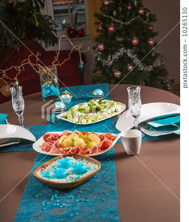 Holiday-decorated table, Christmas tree, ham and melone, and sal 10265130