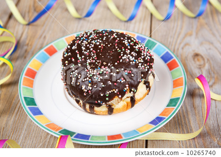 Chocolate and coconut donuts with carnival decoration. 10265740