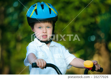 Close up portrait of a cute little boy on bicycle Close up portrait of a cute little boy on bicycle 10277026