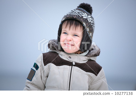 Attractive little boy having fun on winter beach 10277138