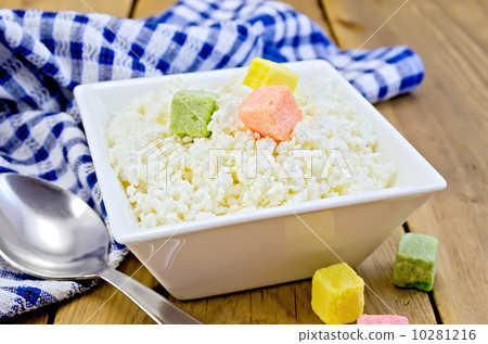 Curd with colored sugar and spoon on board 10281216