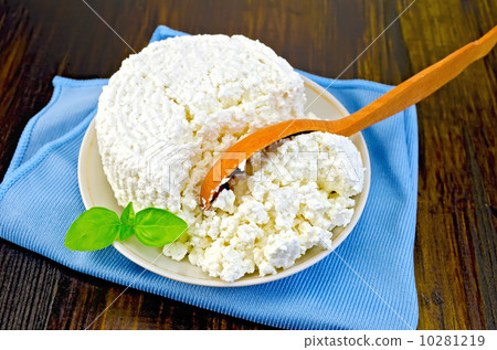 Curd with a wooden spoon on board 10281219