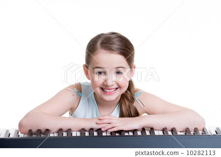 Smiling girl plays on the electric piano. Smiling girl plays on the electric piano. 10282113