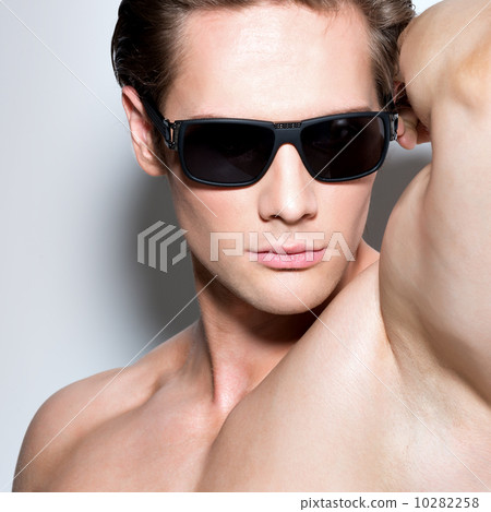 Portrait of young muscular sexy man in glasses. 10282258