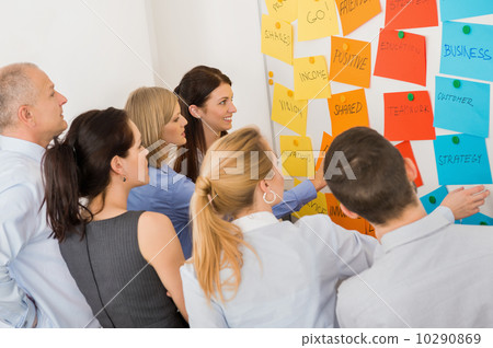 Colleagues Brainstorming In Front Of Whiteboard Colleagues Brainstorming In Front Of Whiteboard 10290869
