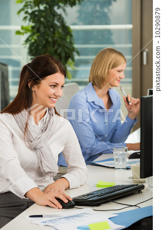 businesswoman using computer at desk - stock phot