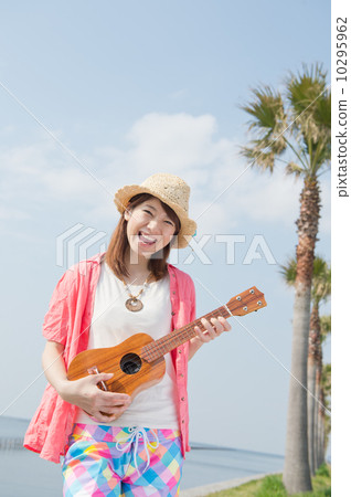A woman in a tropical resort with an ukulele 10295962