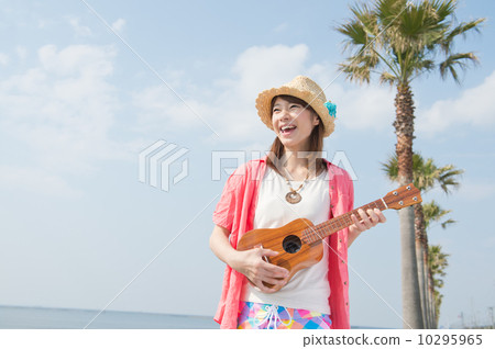 A woman in a tropical resort with an ukulele 10295965