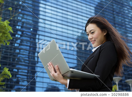 Asian business woman working outdoors with a laptop computer 10298886