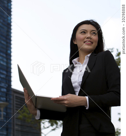 Asian business woman working outdoors with a laptop computer 10298888