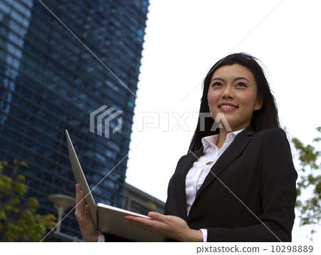 Asian business woman working outdoors with a laptop computer 10298889