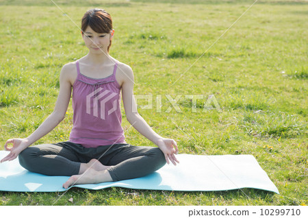 Woman doing yoga in the park Woman doing yoga in the park 10299710