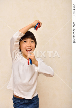 Girl playing with castanet 10303364