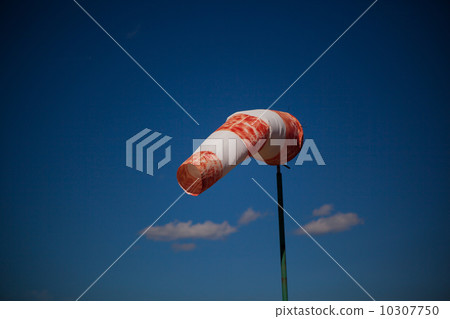 red wind vane against a blue sky 10307750