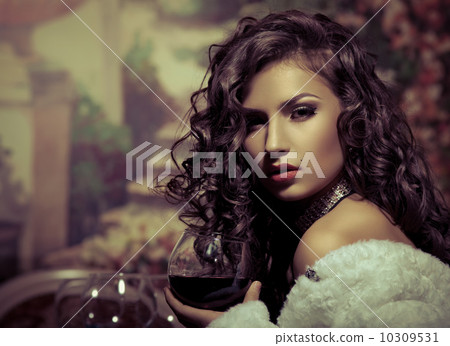 Sexy girl sit with wine in fur coat at evening Sexy girl sit with wine in fur coat at evening 10309531