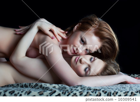 Two playful naked lesbian ladies look at camera Two playful naked lesbian ladies look at camera 10309541