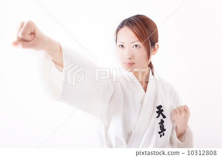 A young Japanese woman in her twenties who karate with a serious expression A young Japanese woman in her twenties who karate with a serious expression 10312808