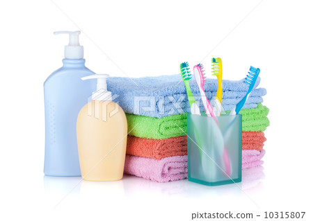 Four colorful toothbrushes, cosmetics bottles and towels Four colorful toothbrushes, cosmetics bottles and towels 10315807