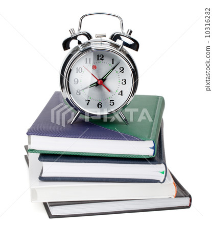 Alarm clock on notepads and books Alarm clock on notepads and books 10316282