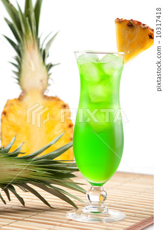 Green tropical cocktail with pineapple slice Green tropical cocktail with pineapple slice 10317418