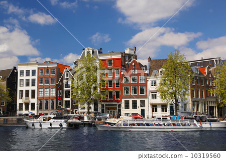 Amsterdam city with boats on canal in Holland Amsterdam city with boats on canal in Holland 10319560