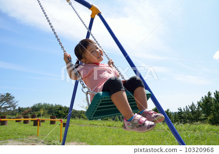 A girl playing with a swing 10320968
