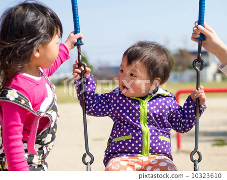 A family playing with a swing A family playing with a swing 10323610