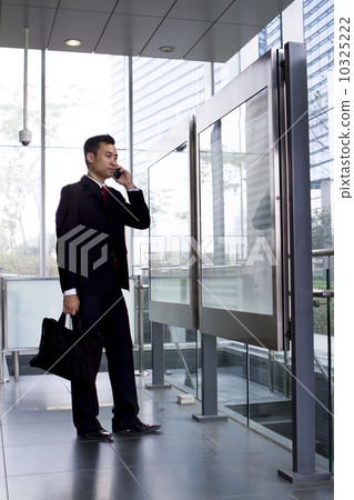 Busy Asian Businessman checking train timetable  10325222
