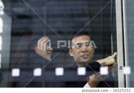 Busy Asian people checking train timetable  10325252