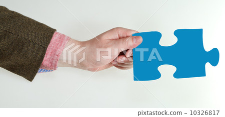 male hand holding blue puzzle piece male hand holding blue puzzle piece 10326817