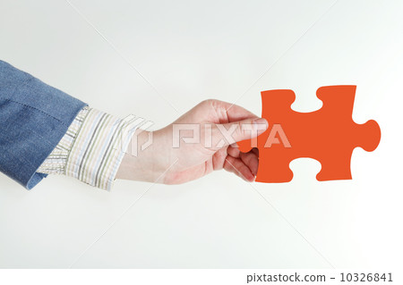 male hand holding red puzzle piece male hand holding red puzzle piece 10326841