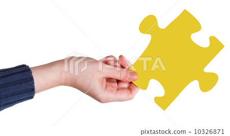 female hand with yellow puzzle piece female hand with yellow puzzle piece 10326871