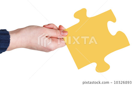 female hand with yellow puzzle piece female hand with yellow puzzle piece 10326893
