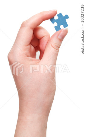female hand holding blue puzzle piece 10327239