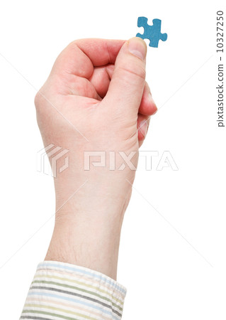 male hand in shirt holding jigsaw puzzle piece male hand in shirt holding jigsaw puzzle piece 10327250