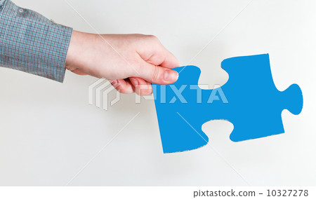 female hand holding blue puzzle piece female hand holding blue puzzle piece 10327278