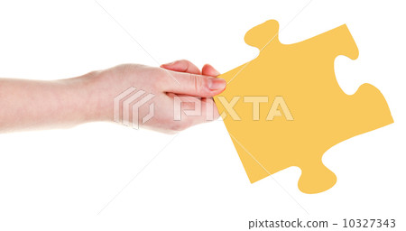 female hand with yellow puzzle piece female hand with yellow puzzle piece 10327343