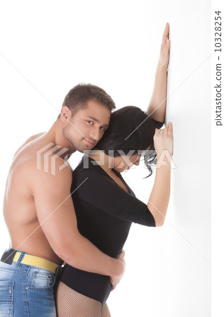 Hugging lovers posing in studio 10328254